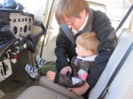 Noah getting strapped in for his first flight with Tim